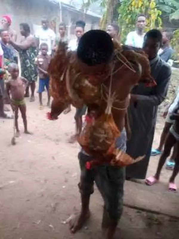 Teenager caught stealing chickens, stripped naked, beaten and paraded (Photos)